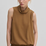 The Herskind ApS Loa Top is a sleeveless brown garment in a relaxed fit with a high, draped cowl neckline.